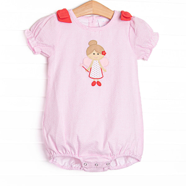  This bubble features a pink seersucker material, fairy applique, red shoulder bows, and short puff sleeves. 