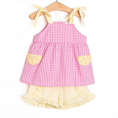 This set features a pink gingham print, yellow seersucker straps, and lemon slice appliques. Coordinating yellow seersucker shorts to match. 