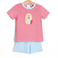 This set features a red striped print, blue trim, and a puppy beach ball applique. Coordinating blue shorts to match.