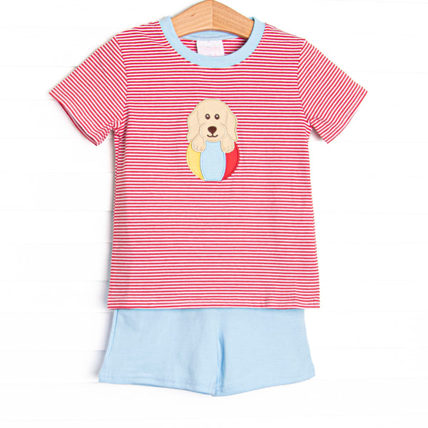 This set features a red striped print, blue trim, and a puppy beach ball applique. Coordinating blue shorts to match.