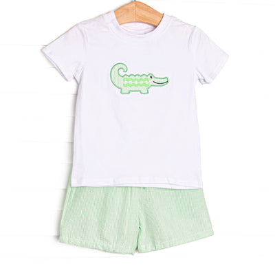 This set features a short sleeve top with flutter sleeves with an alligator applique and coordinating green seersucker shorts to match.