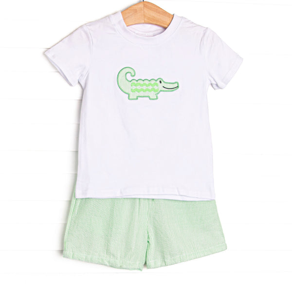 This set features a short sleeve top with flutter sleeves with an alligator applique and coordinating green seersucker shorts to match.