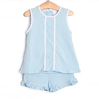  This set features a blue knit material, white trim, and ruffle shorts to match. 