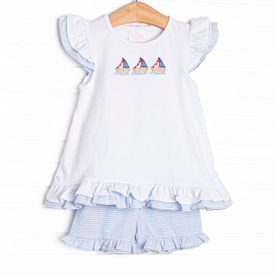  This set features a flutter sleeve top with a trio of sailboat embroidery and blue striped ruffle shorts to match. 