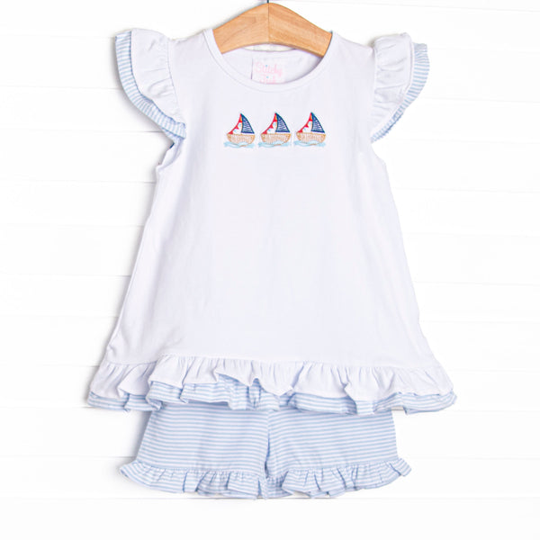  This set features a flutter sleeve top with a trio of sailboat embroidery and blue striped ruffle shorts to match. 