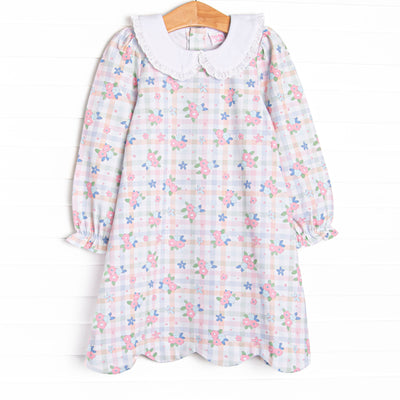  This dress features a pastel gingham fabric with pink florals, long sleeves, and a white eyelet lace trimmed Peter Pan collar. 