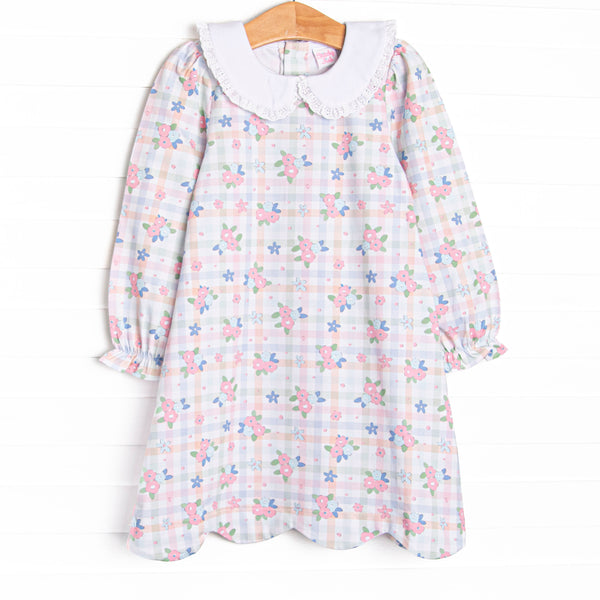  This dress features a pastel gingham fabric with pink florals, long sleeves, and a white eyelet lace trimmed Peter Pan collar. 