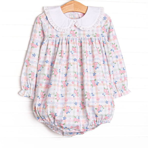  This bubble features a pastel gingham fabric with pink florals, long sleeves, and a white eyelet lace trimmed Peter Pan collar. 