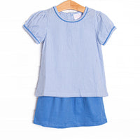 This set features a blue gingham top, short puff sleeves, and a blue corduroy skirt.