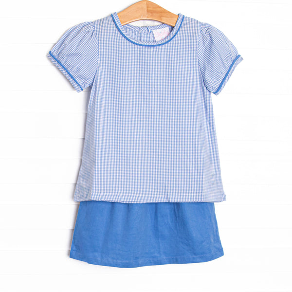 This set features a blue gingham top, short puff sleeves, and a blue corduroy skirt.