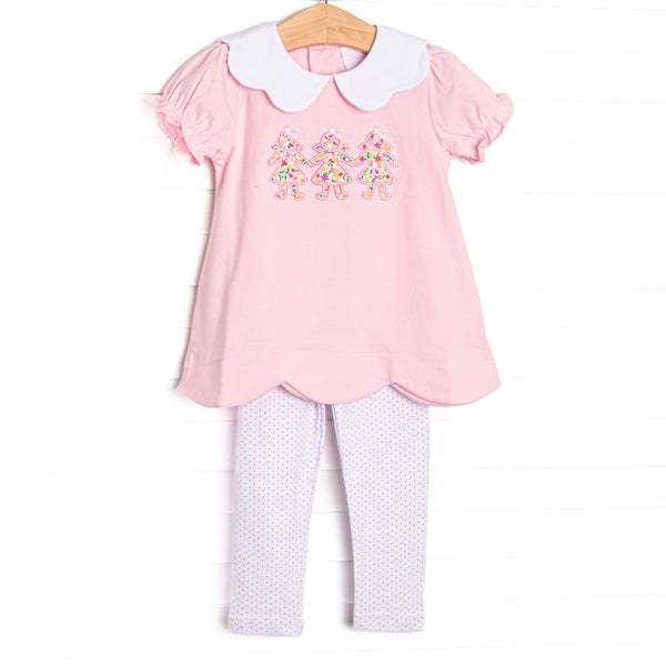 This set features pink knit fabric, a white scalloped collar, short puff sleeves, and paper doll floral applique. Coordinating dotted leggings to match.