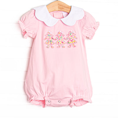  This bubble features pink knit fabric, a white scalloped collar, short puff sleeves, and paper doll floral applique. 