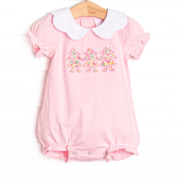  This bubble features pink knit fabric, a white scalloped collar, short puff sleeves, and paper doll floral applique. 