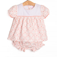 This set features pink check fabric, pink flowers, a white bib collar, and short puff sleeves. Coordinating diaper cover to match.