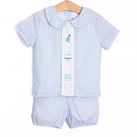 This birthday set features light blue seersucker fabric, birthday embroidery, and short sleeves. Coordinating bloomers to match.