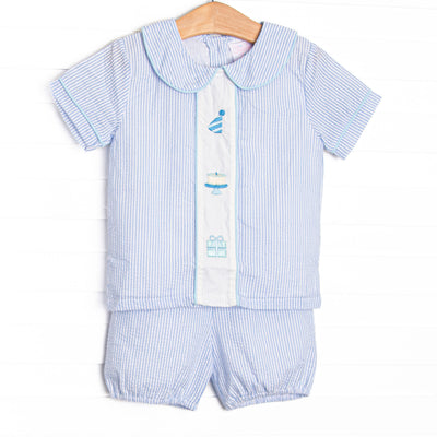 This birthday set features light blue seersucker fabric, birthday embroidery, and short sleeves. Coordinating bloomers to match.
