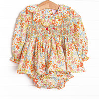  This smocked set features floral print, a scalloped collar, and long sleeves. Coordinating diaper cover to match. 