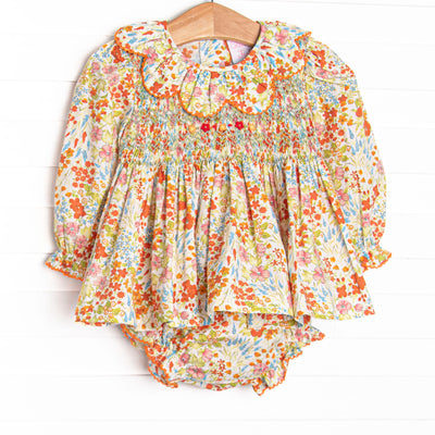 This smocked set features floral print, a scalloped collar, and long sleeves. Coordinating diaper cover to match. 