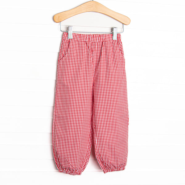 Featured in blue and red gingham, with front pockets, and ankle cuffs.