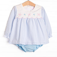 This set features a blue gingham top with a bib collar and bows and flowers appliques. Coordinating blue diaper cover to match.