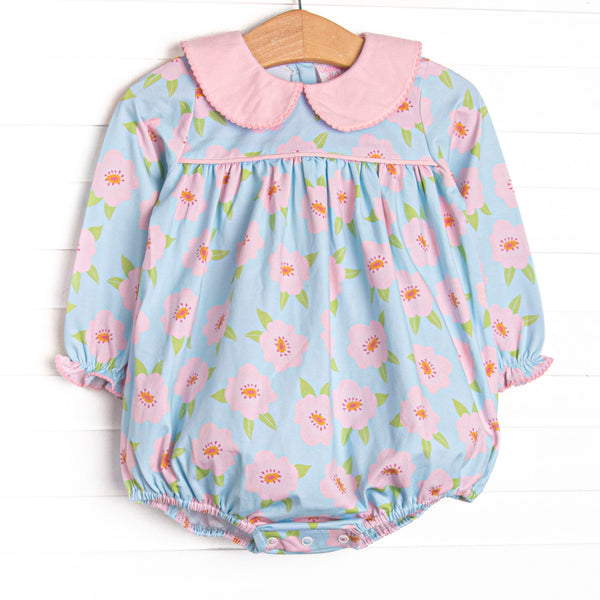  This bubble features a pink and blue floral printed knit fabric, long sleeves, pink piping, and a pink Peter Pan collar. 