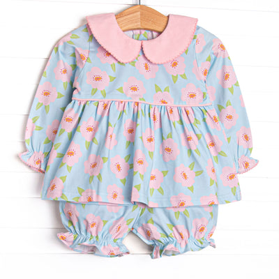 This set features a pink and blue floral printed knit fabric, long sleeves, pink piping, and a pink Peter Pan collar. Coordinating bloomer shorts to match.