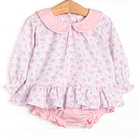  This set features a pink floral print, long sleeves, a ruffle hem, and a pink Peter Pan collar. Coordinating diaper cover to match. 