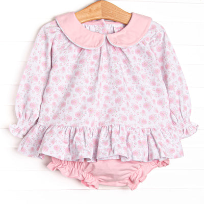  This set features a pink floral print, long sleeves, a ruffle hem, and a pink Peter Pan collar. Coordinating diaper cover to match. 