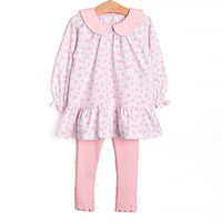  This set features a pink floral print, long sleeves, a ruffle hem, and a pink Peter Pan collar. Coordinating scalloped leggings to match. 