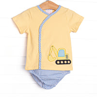 This set features a yellow short sleeve top with a blue gingham trim and an excavator applique. Coordinating blue gingham diaper cover to match.