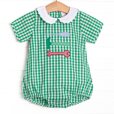 This bubble features a green gingham print, a peter pan collar, and a tool trio appliques.