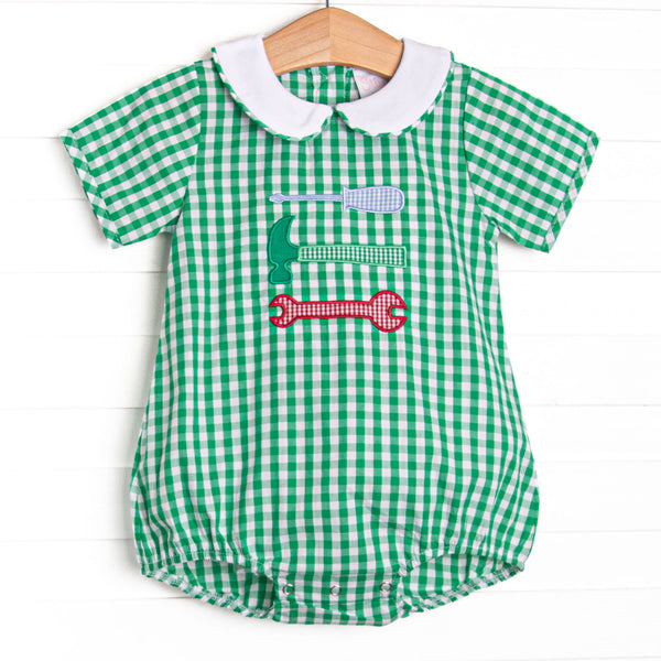 This bubble features a green gingham print, a peter pan collar, and a tool trio appliques.