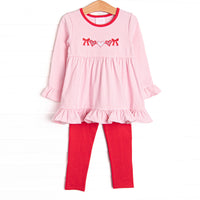 This precious set features a pink striped&nbsp; top with ruffle hem details and a heart string applique. Red leggings to match.