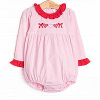  This precious bubble features a pink striped print, red ruffle trim details and a heart string applique. 