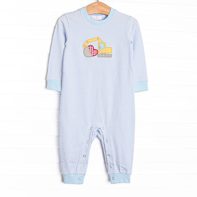  This romper features a blue striped print, an excavator applique, and snaps on the stride. 