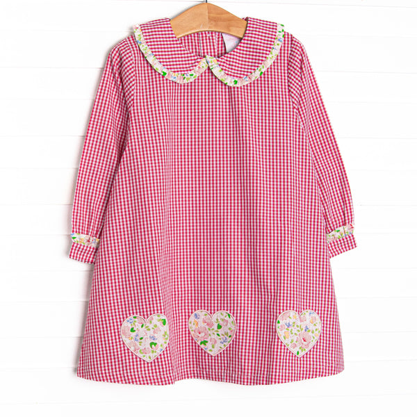  This dress features a red mini gingham print, a peter pan collar with ruffle trim, and floral heart appliques. 