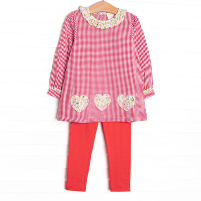 This set features a red mini gingham print, a ruffle collar, and floral heart appliques. Coordinating red leggings to match