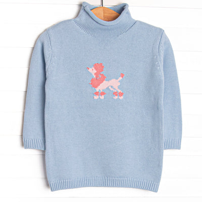 This sweater features blue knit material, a pink poodle icon, and a rolled neck.
