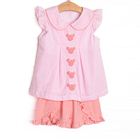 This set features pink gingham fabric, mouse embroidery, flutter sleeves, and a Peter Pan collar. Coordinating ruffle shorts to match.