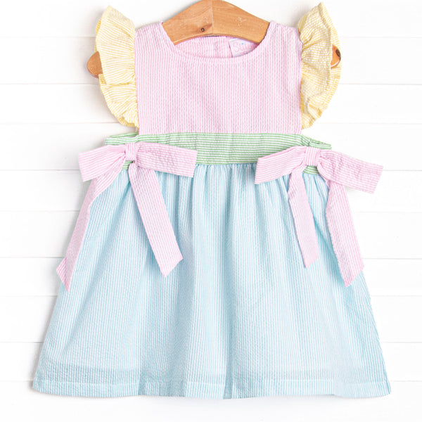  This dress features precious pastel seersuckers, flutter sleeves, and bows on the sides. 