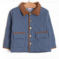 This coat features a denim quilted material, brown collar and trim, and light blue gingham lining.