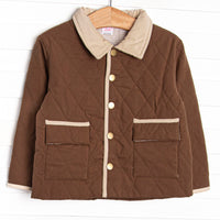  This coat features a brown quilted material, brown tan and trim, and tan gingham lining. 