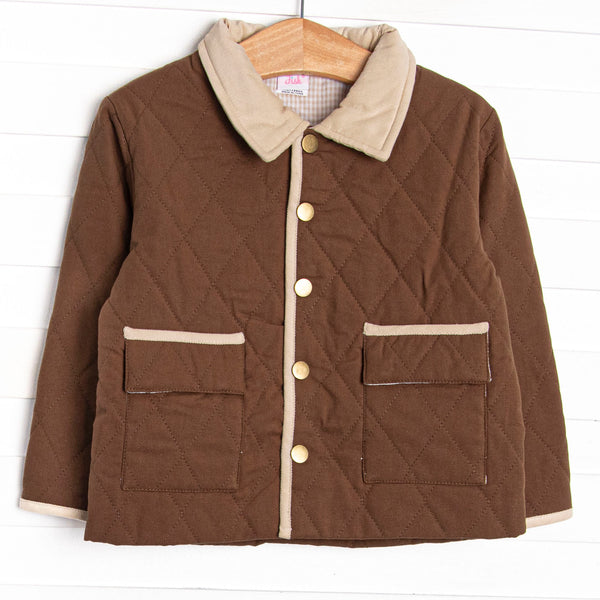  This coat features a brown quilted material, brown tan and trim, and tan gingham lining. 
