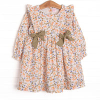  This dress features a green floral print, green bows, and flutter shoulder details. 
