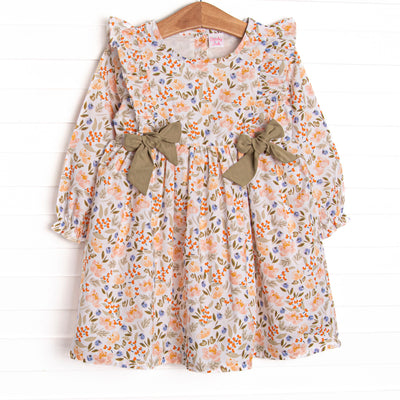  This dress features a green floral print, green bows, and flutter shoulder details. 