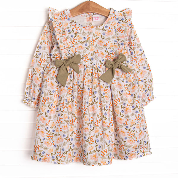  This dress features a green floral print, green bows, and flutter shoulder details. 