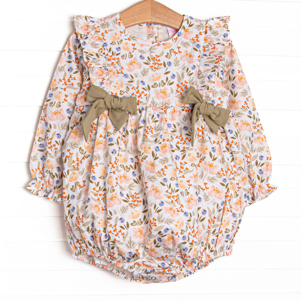  This bubble features a green floral print, green bows, and flutter shoulder details. 
