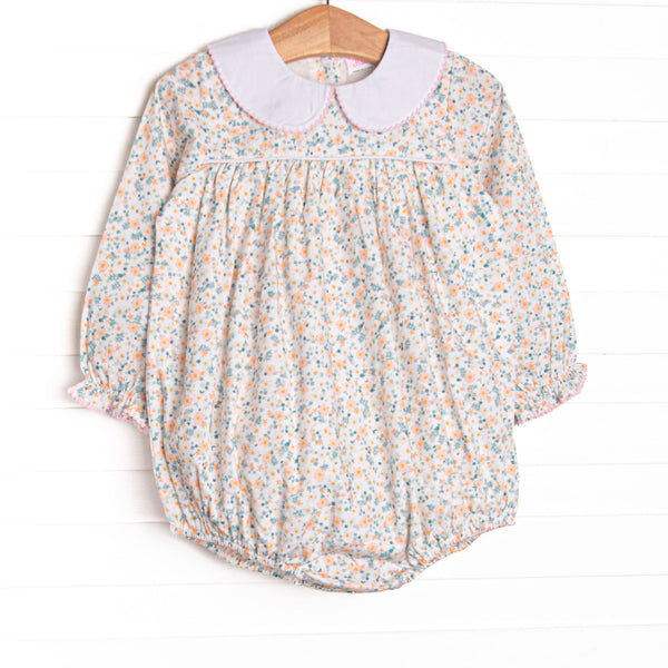 This bubble features a dainty floral print, snaps on the stride, and a peter pan collar with picot trim.