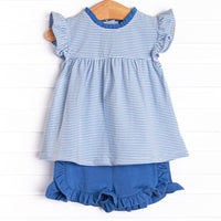 The set features a blue striped flutter sleeve top, the softest knit material, and blue ruffle shorts to match.
