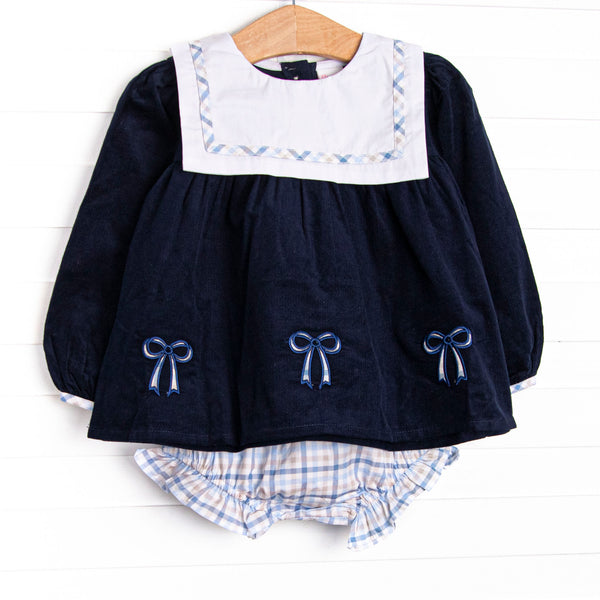  This set features navy corduroy material, a bib with blue plaid trim, and blue bow appliques. Coordinating blue plaid diaper cover to match. 